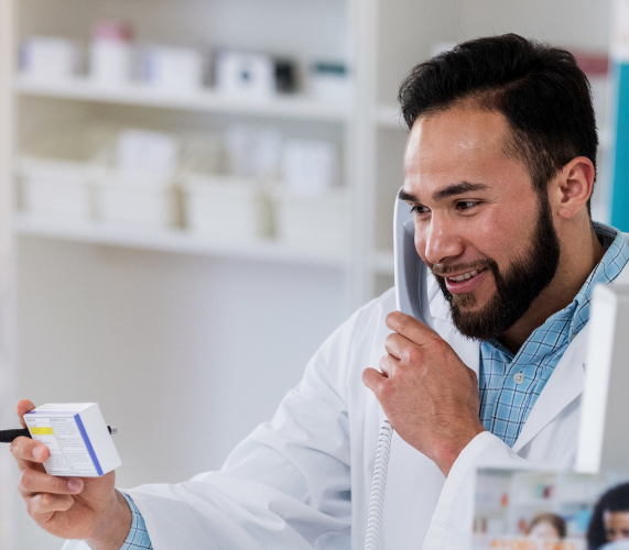 Pharmacist and customer talking over the phone regarding over-the-counter medications